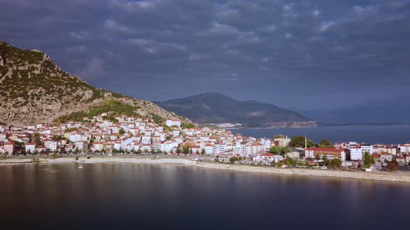 Touristic Coastal City with Road Leading Along Shore Built on the Foot of Mountain Range