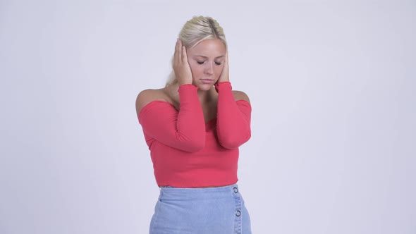 Young Stressed Blonde Woman Covering Ears From Loud Noise