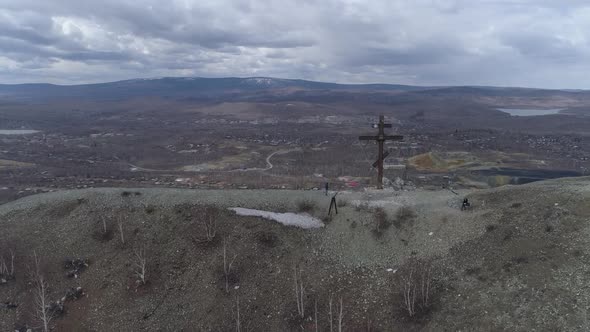 Orthodox cross on Mount Karabash and city view. The camera rises 05