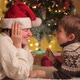 Smiling Boy Palying with Mother's Santa Hat on Christmas Eve - VideoHive Item for Sale