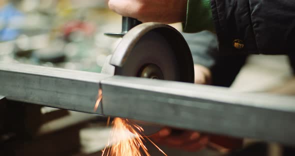 Steel Industry - Man Using Angle Grinder Grinding Metal Object.