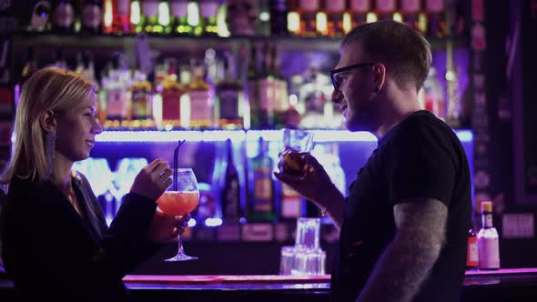 Adult Man Meets a Woman Standing Near the Bar Counter and Talks To Her