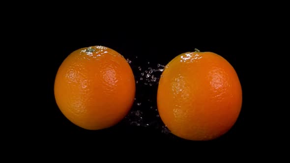 Large Juicy Oranges are Flying and Colliding with Each Other in Slow Motion