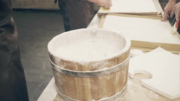 A Muscular Man Mixes a Mixture of Gypsum in a Hand-made Workshop That Makes Decorative Gypsum Panels