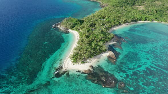 Pristine tropical island in Fiji with stunning turquoise water and white beach