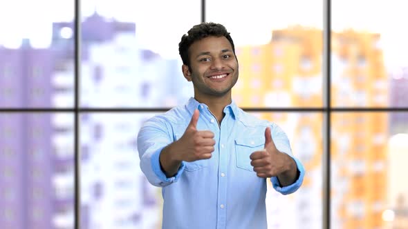 Portrait of a Happy Young Darkskinned Hindu Man Shows Both Thumbs Up