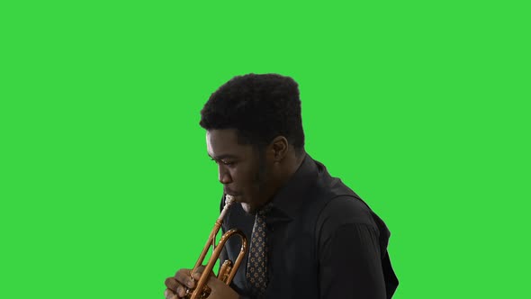 African American Musician Playing the Trumpet Expressively on a Green Screen, Chroma Key.