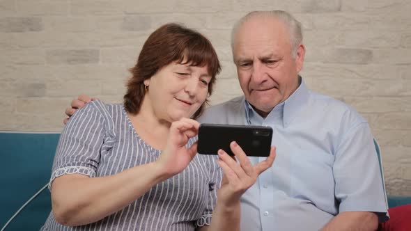 Grey Haired Pensioner Is Helping By His Aged Wife with New Smartphone App