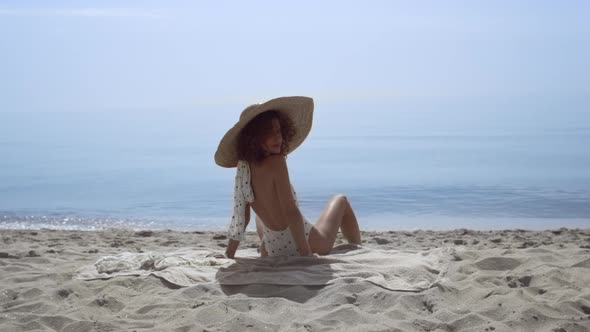 Stylish Woman Turning Back Sitting Sunny Seashore