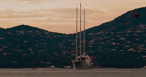 A Huge Yacht of Conceptual Design with Three Masts Stands in the Bay of St