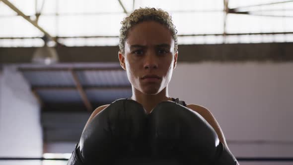 Mixed race woman with boxing gloves