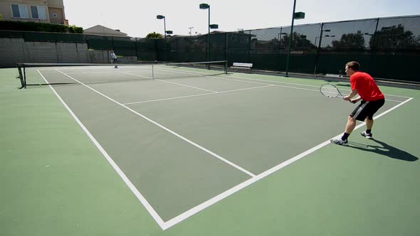 A man serving an ace tennis serve to his opponent.