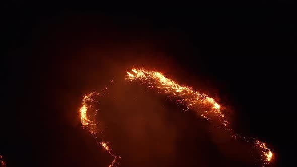 Aerial View. Dangerous Fire in the Field. Night Fire, Natural Disaster.