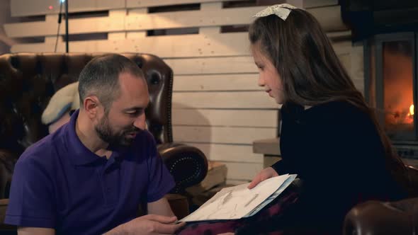 Pretty Daughter Describing Her Paintings To Father