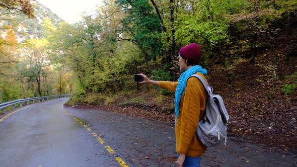 Woman Alone in Nature Raising Smartphone Above Signal Problem