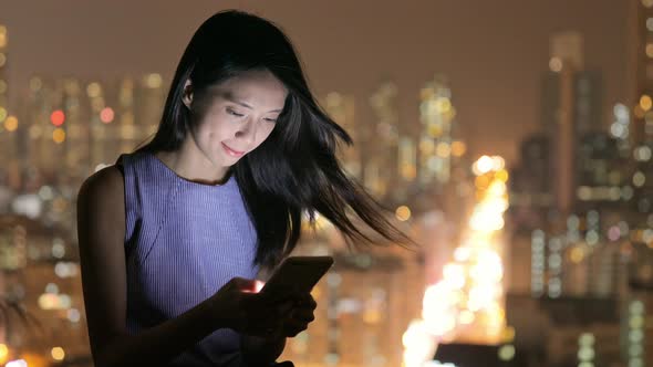 Woman use of cellphone at night