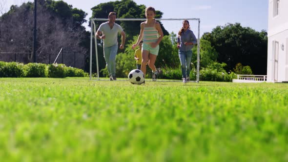 Happy family playing football