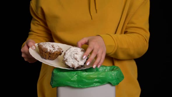 Woman Scraping with a Plate a Cupcakes or Muffins Into Garbage Bin