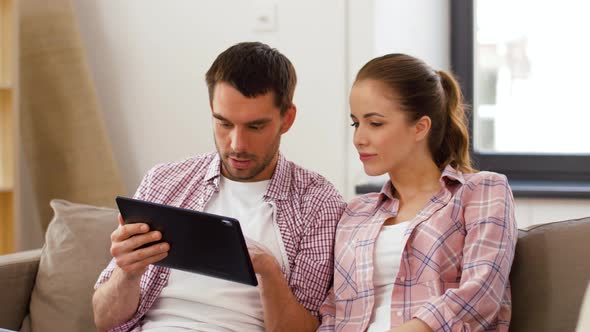 Happy Couple with Tablet Pc Computer at New Home