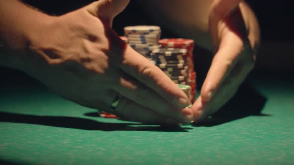 Croupier Moves Chips On Table At Casino.