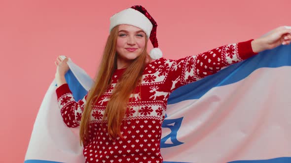 Adult Girl Patriot in Christmas Sweater Waving and Wrapping in Israel National Flag Celebrating