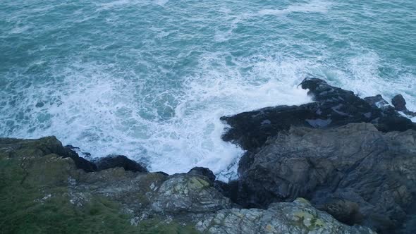 Aerial slow motion of waves crashing against UK coast