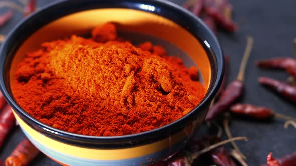 Chili Powder and Dried Peppers on Table Background.