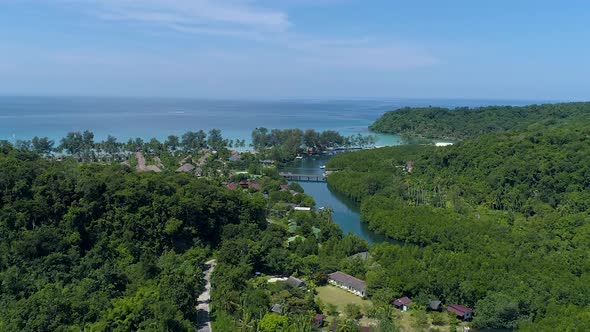 Drone shot of estuary on tropical island with resorts on the beach. Koh kood island. ZOOM OUT