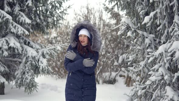 Young Woman Is Walking Along a Beautiful Winter Forest