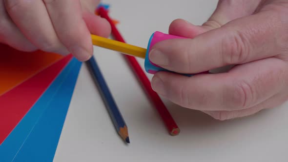 The Artist Sharpens a Yellow Pencil