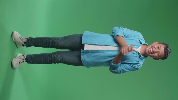 Full Body Of Young Asian Boy Clapping Her Hands In The Green Screen Studio