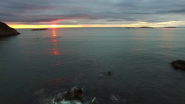 Rocky coast and midnight sun in Norway.