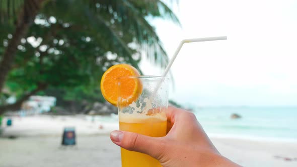 Fresh Juices From Tropical Fruits in Glasses on Table By The Exotic Beach Close Up