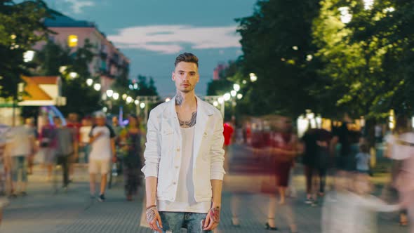 Time Lapse of Attractive Male Hipster Standing in Urban Street in the Evening