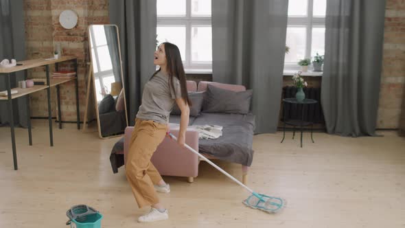 Woman Dancing and Mopping Floor