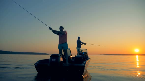 Men Are Catching Fish From an Autoboat in the Open Water