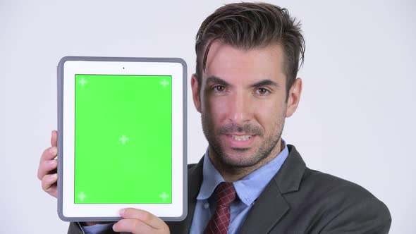 Young Happy Hispanic Businessman Showing Digital Tablet