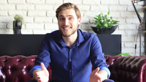 Confident happy businessman talking to camera making video conference from home during self isolatio