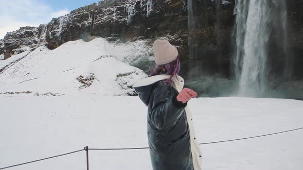 Beautiful Woman Around Seljalandsfoss Waterfall in Iceland at Winter