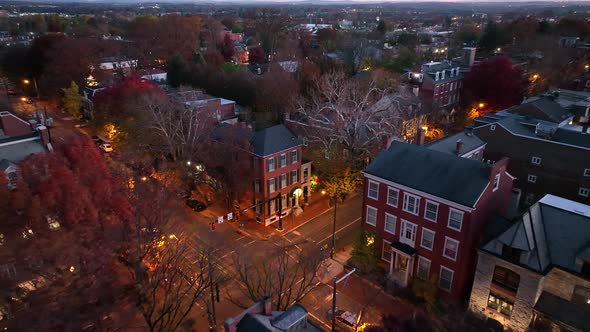 Aerial pullback reveals urban city town in USA. Historic homes in residential district. Establishing