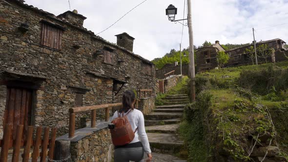 Woman walking in Talasnal schist village, in Portugal