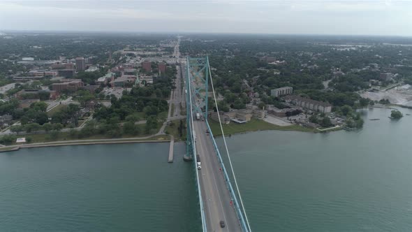 This video is about an aerial of the Ambassador Bridge over the Detroit river near downtown Detroit.