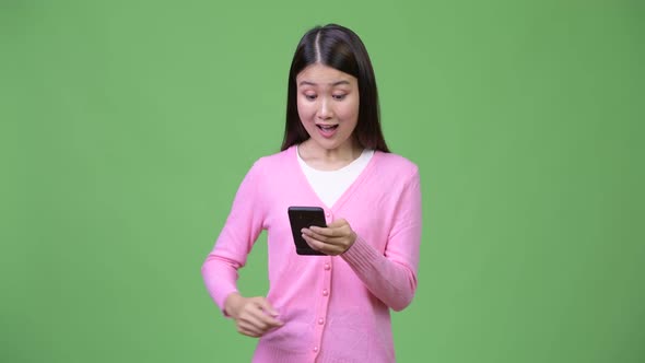 Young Beautiful Asian Woman Using Phone