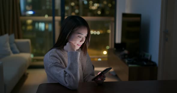 Woman use of mobile phone at home 