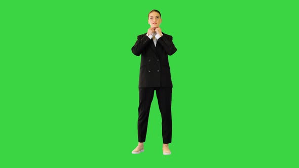 Young Woman Adjusting Her Office Suit Crossing Arms Putting Hand on Hip on a Green Screen Chroma Key