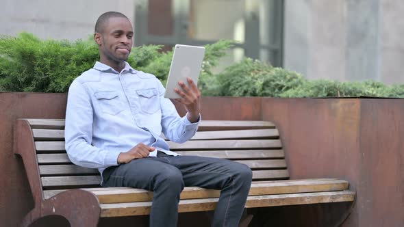 Cheerful Young African Man Doing Video Chat on Tablet