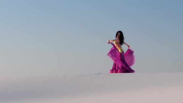 Professional Dancer in a Shiny Suit Makes Sexual Movements Against the Blue Sky