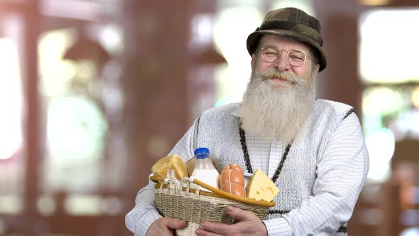 Happy Bearded Man Holding Basket of Dairy Products.