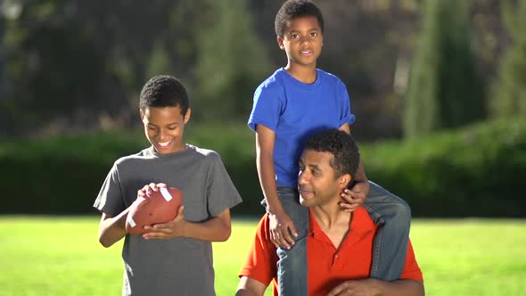 Group portrait of a father and his sons with a football