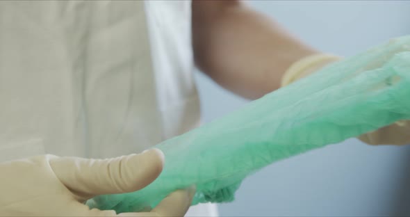 Doctor in Protective Suit and Gloves Wearing Cap. Nurse in Protective Suit with Gloves Wearing Cap